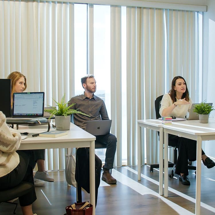 The Site comms team working at their desks