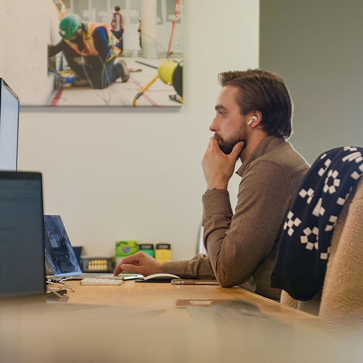 A man working on marketing at a computer