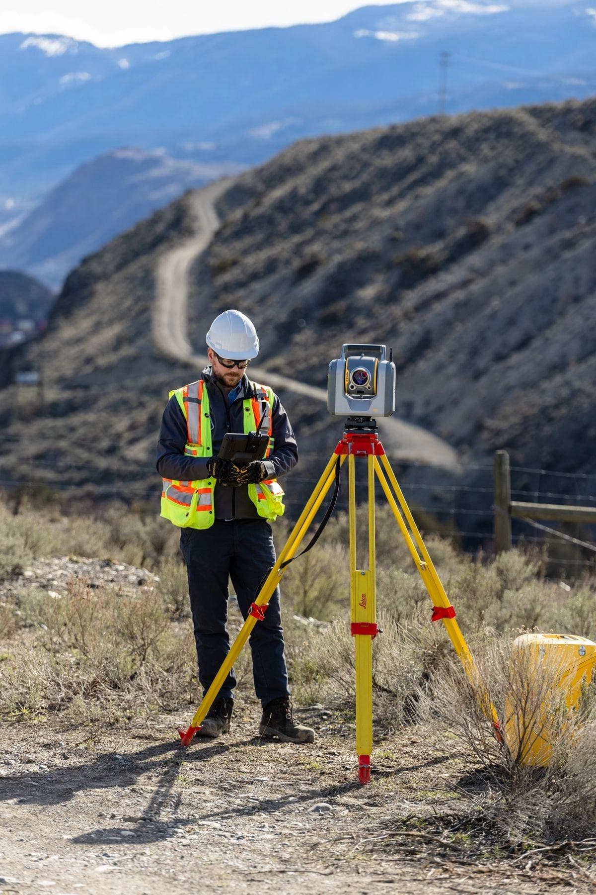 An Underhill employee using surveying equipment in the field.