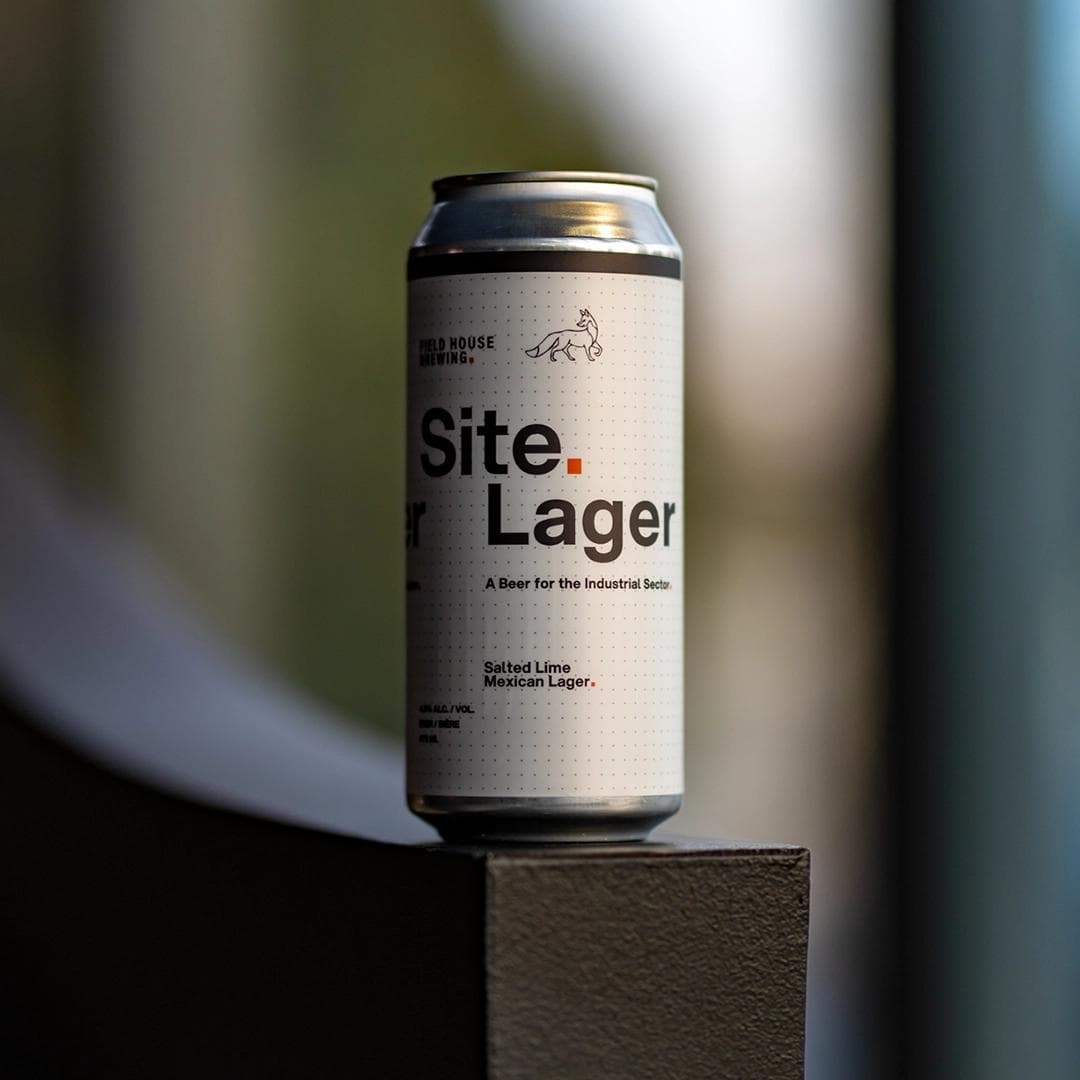 A Site Lager sitting on the handrail in the lobby of Site HQ